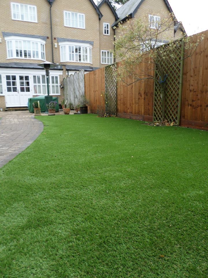 An artificial grass lawn behind a house