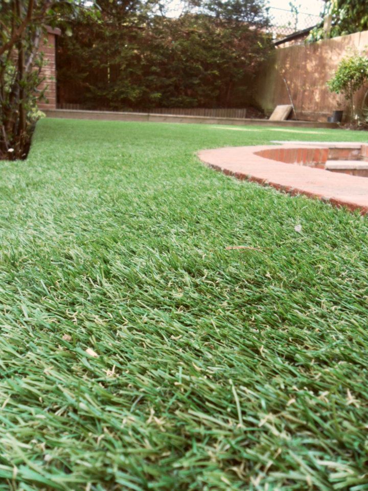 A freshly installed artificial-grass lawn in a back garden