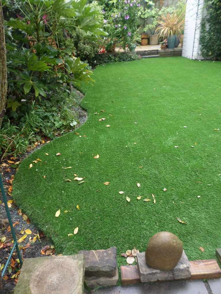 An artificial grass lawn in a small garden
