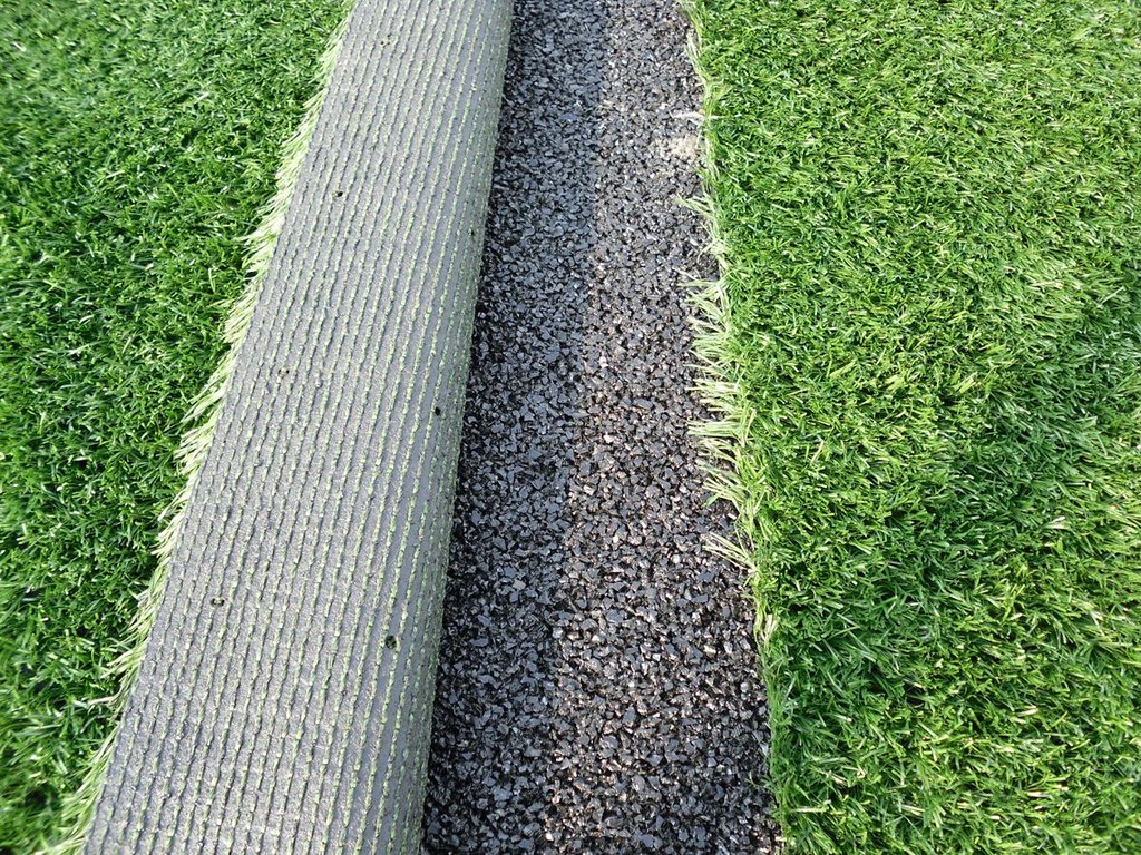 A rubber shock pad going under artificial grass