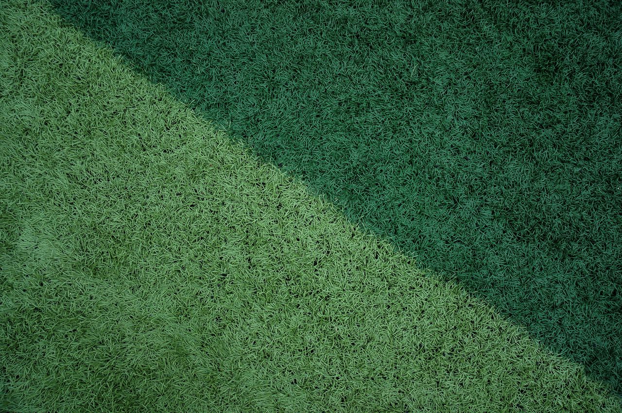 Green synthetic turf surface