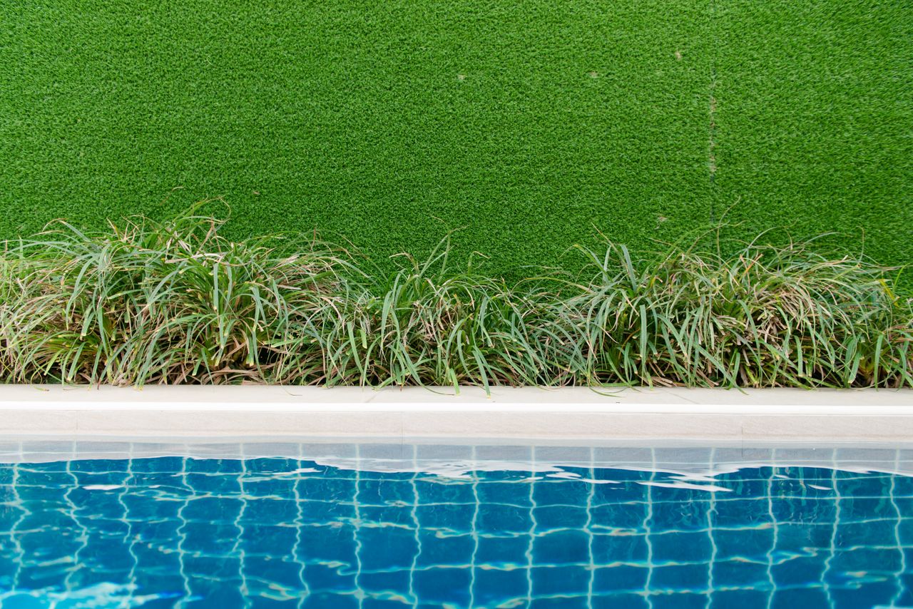 Artificial turf laid beside a swimming pool