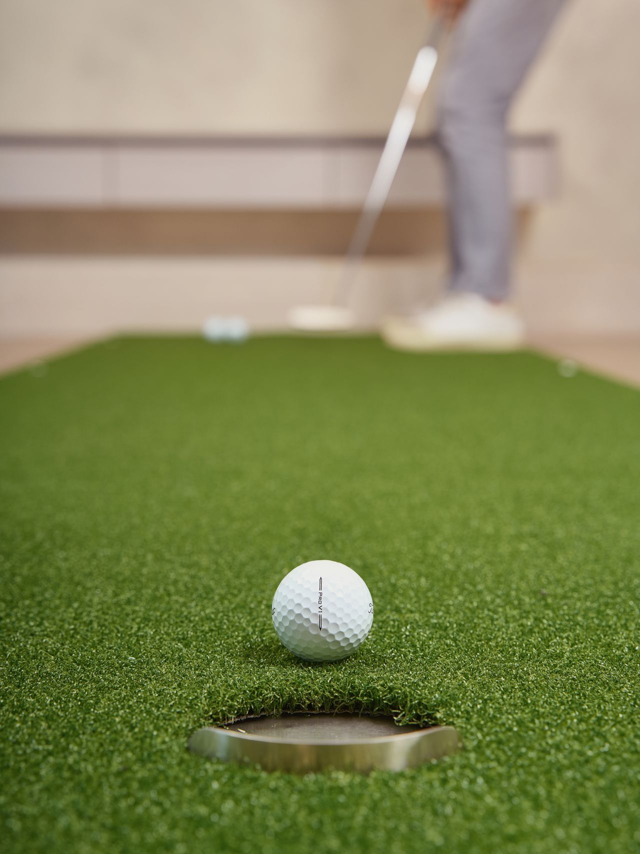 A golf ball on an artificial putting green